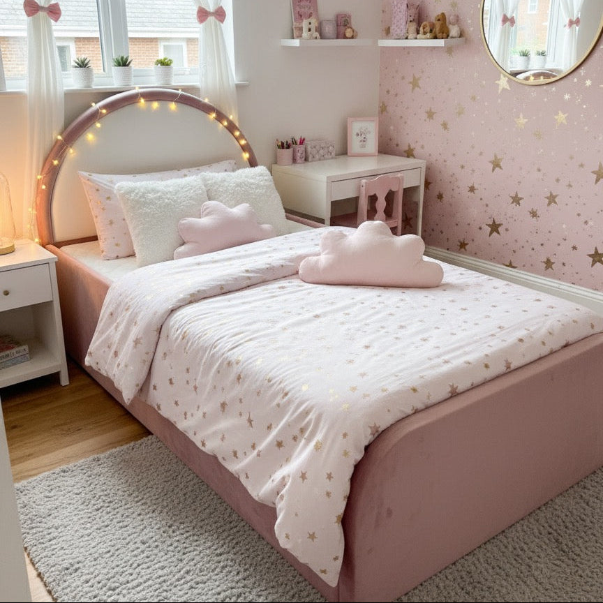 Pink bedroom with star-patterned wallpaper, bed with cloud-shaped pillow, and shelves with decorative items.