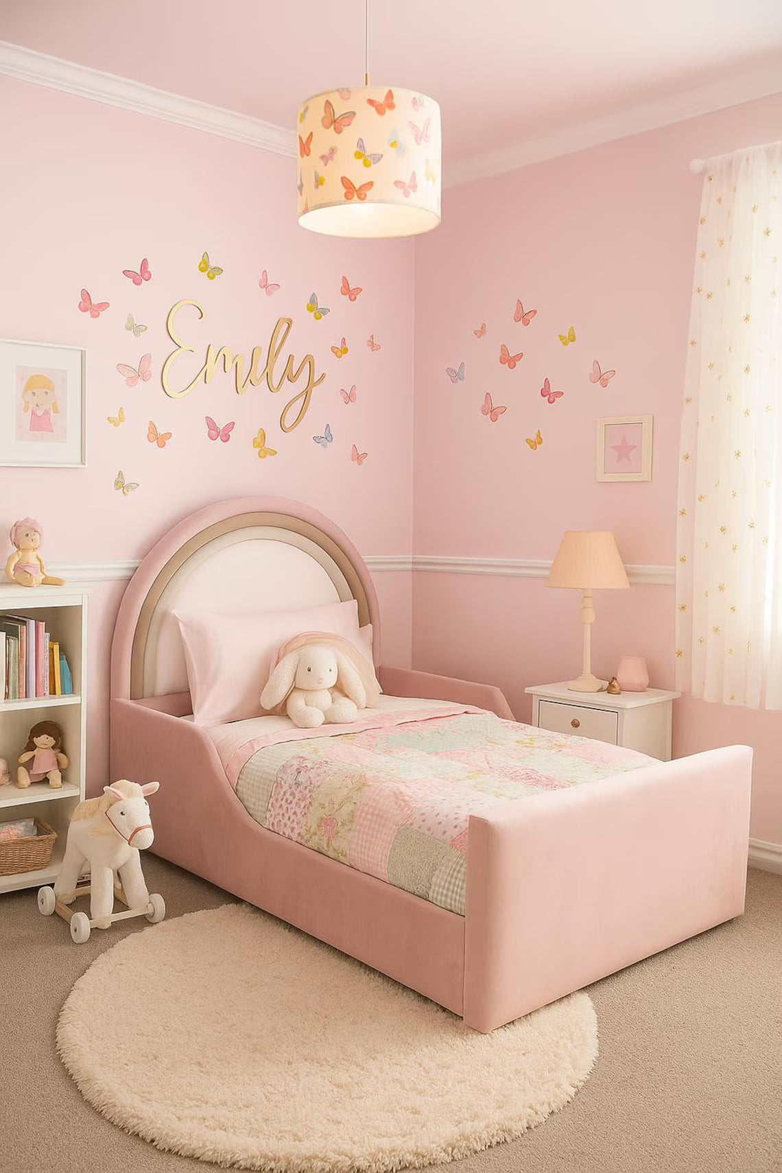 Children's bedroom with pink walls, a bed, and decorative elements.