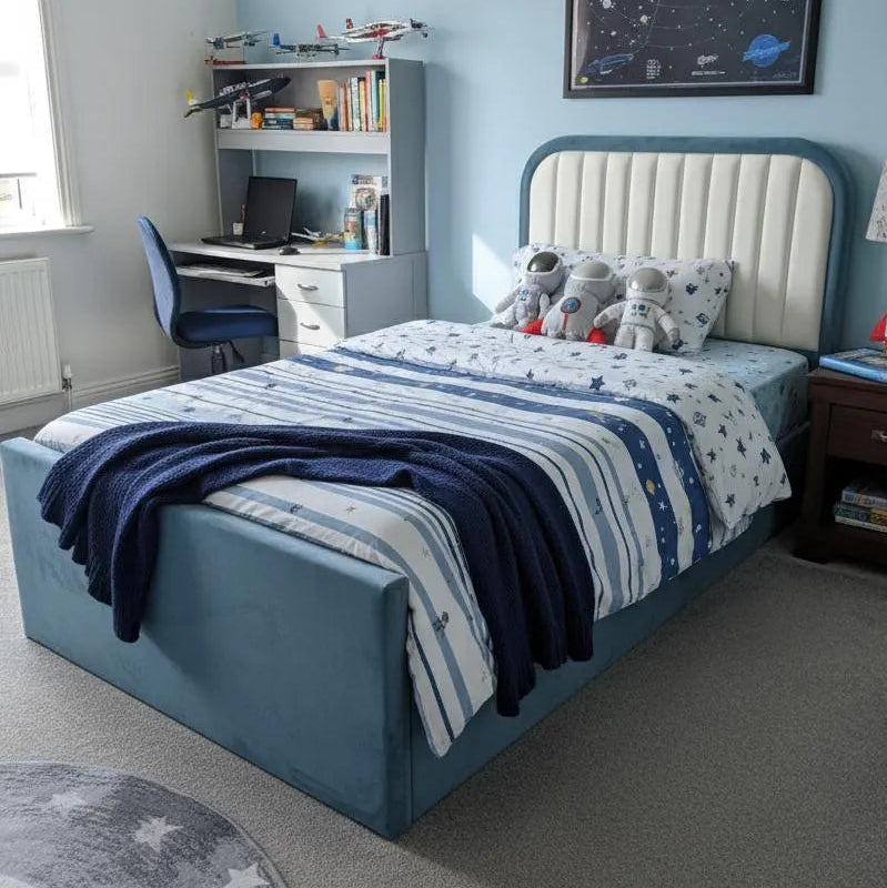 Children's bedroom with blue bed, desk, and decor elements.