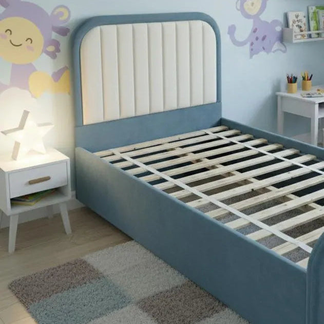 Children's bedroom with blue bed, wall decorations, and rug.