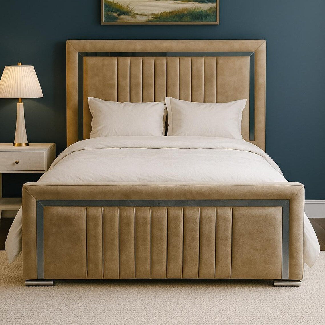 Beige upholstered bed in a bedroom with a lamp and painting on the wall.